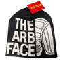 A black and white cotton beanie with 'ARB FACE' text and logo on it, with a tag showing the brand name 'ARB Fictions'.