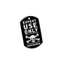 A black anodized aluminum metal tag with white text saying 'EXPERT USE ONLY' and a skull and crossbones symbol below it, and the brand 'rock exotica' mentioned at the bottom.