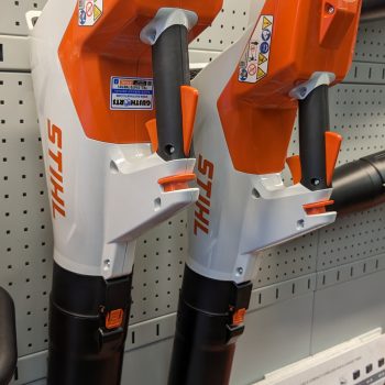 Unlocking the Value: Are Stihl Leaf Blowers Worth the Investment? Stihl leaf blowers displayed on a pegboard.