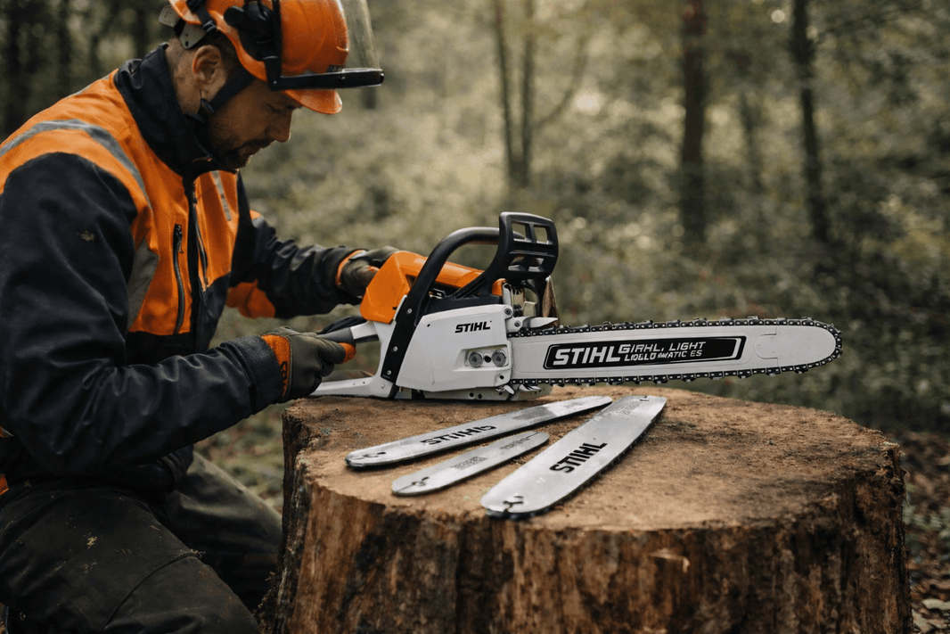 A tree surgeon setting up a STIHL chainsaw with guide bar and chain on a log, demonstrating how to choose the right guide bar & chain combo for your chainsaw.