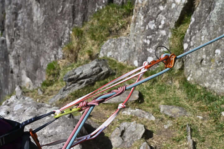 DMM Slings used in tree surgeon rigging and load management with durable textile connections on rocky terrain.