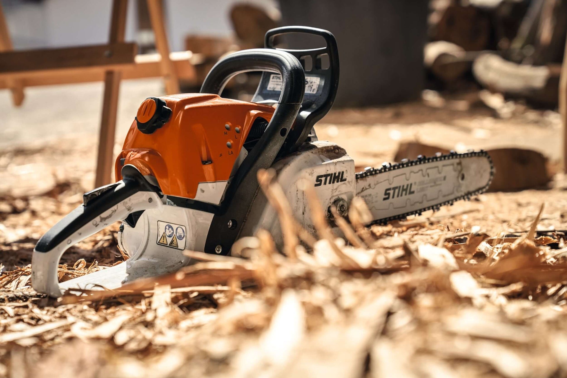 Close-up of a STIHL chainsaw on the ground, showcasing quality equipment for tree surgeons and garden maintenance.