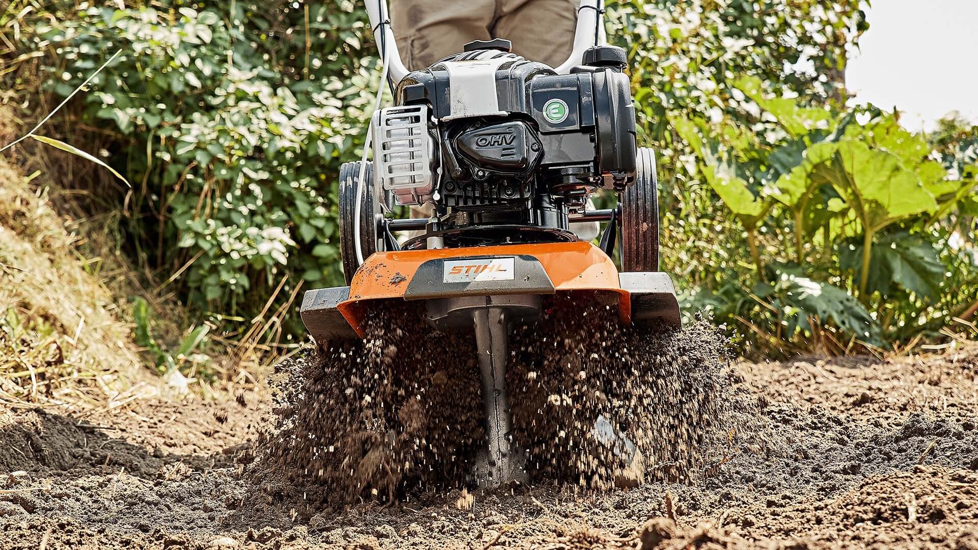 STIHL tiller in action, optimizing soil for gardening tasks, backed by genuine accessories for maximum efficiency.