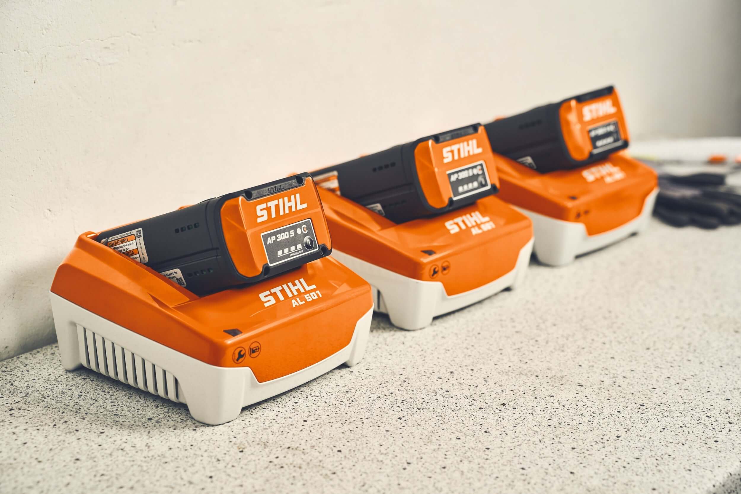 STIHL Batteries displayed on a countertop, showcasing AS and AP battery systems for outdoor equipment.
