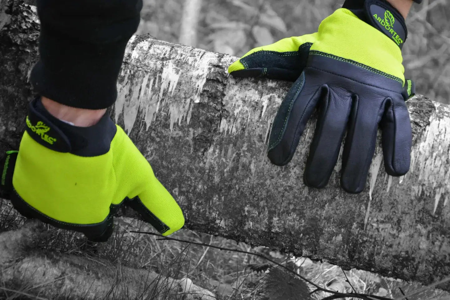 Arbortec gloves in use by a tree surgeon, gripping a log with durable protection and comfort.