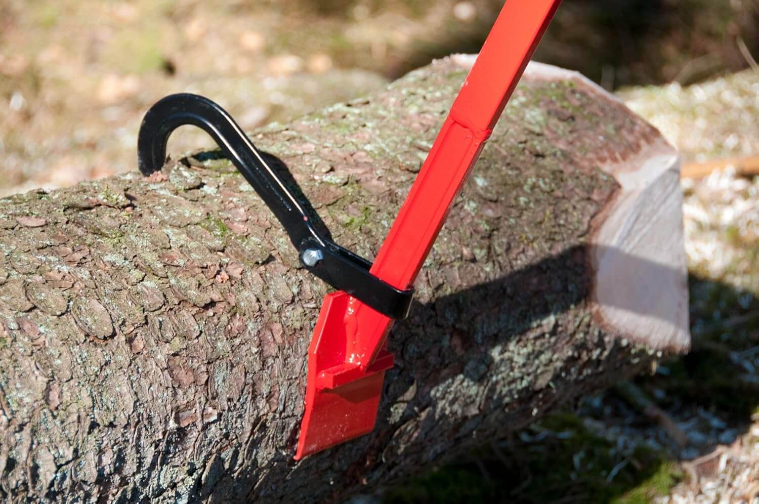 Close-up of log tongs gripping a timber log, ideal for tree surgeons and landscaping professionals.