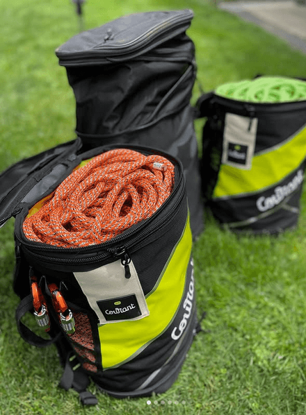 Tree surgeon rope bags by Courant, featuring durable designs and vibrant ropes in a grassy setting.