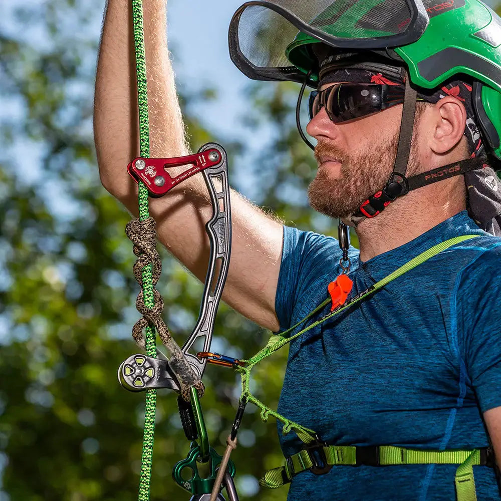 Tree surgeon using ISC Rope Wrench for arborist climbing with single rope technique outdoors.