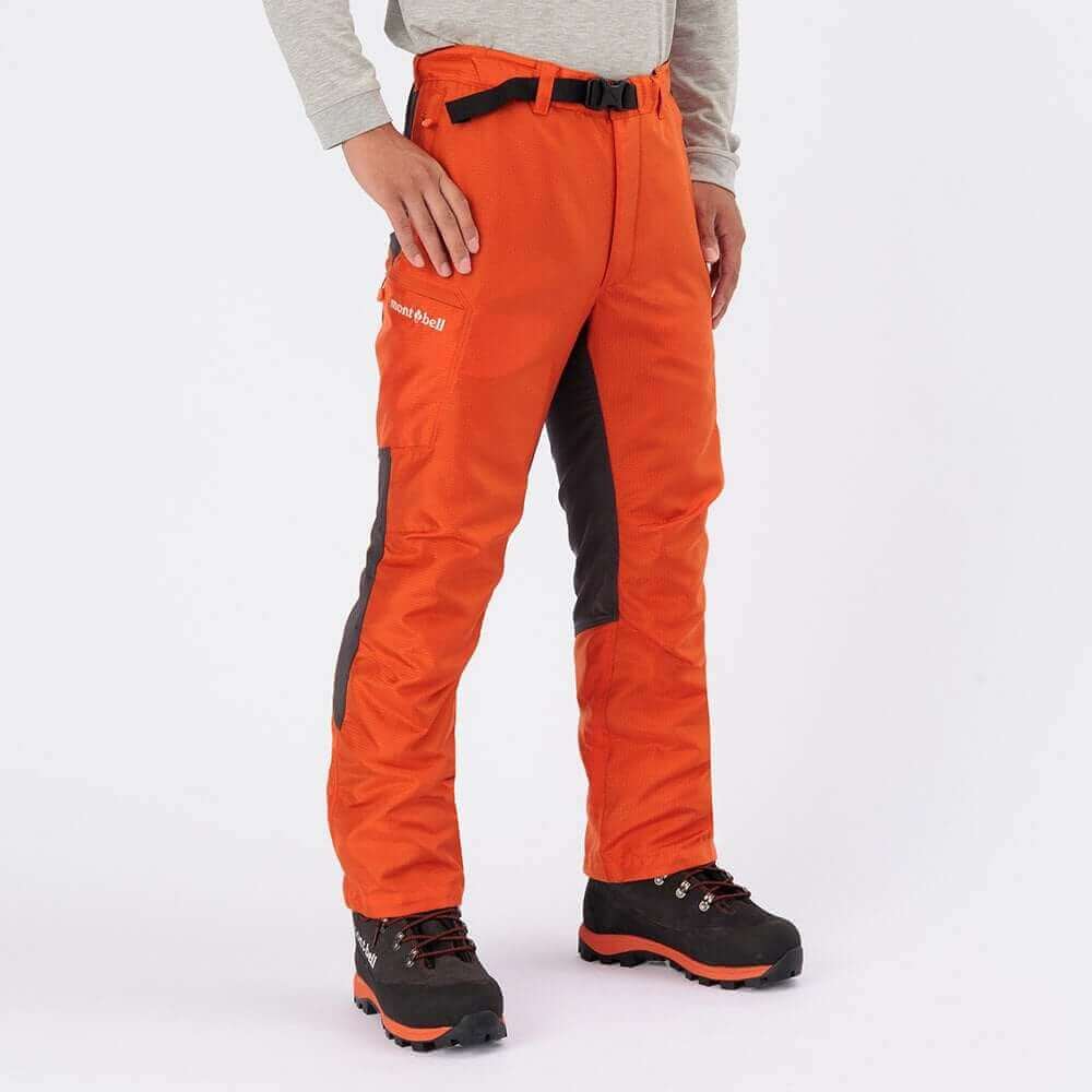 Tree surgeon wearing Montbell orange pants designed for mobility and protection in forestry work.