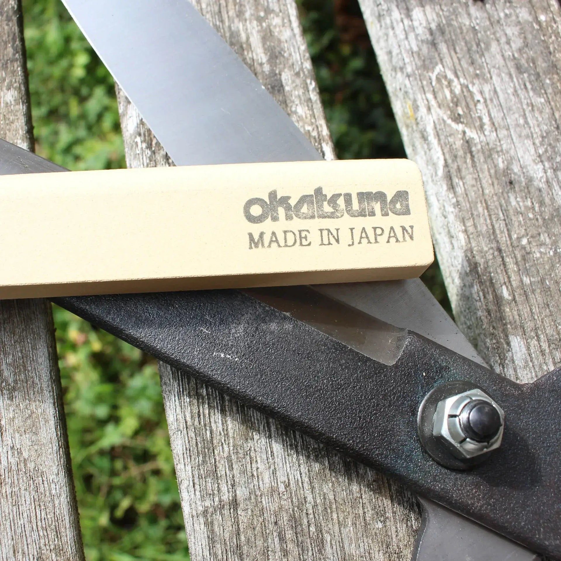 Close-up of a sharpening file and pruning saw for Hand Saw Files collection, featuring Okatsuna Made in Japan branding.