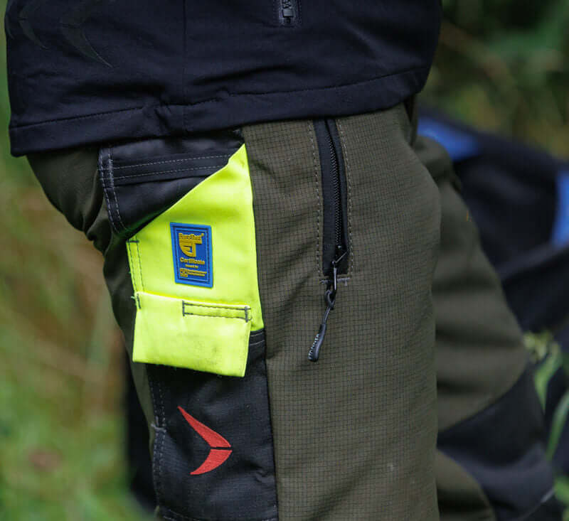 Detail of Pfanner Ventilation Chainsaw Trousers showcasing reinforced fabric and bright safety accents for tree surgeons.