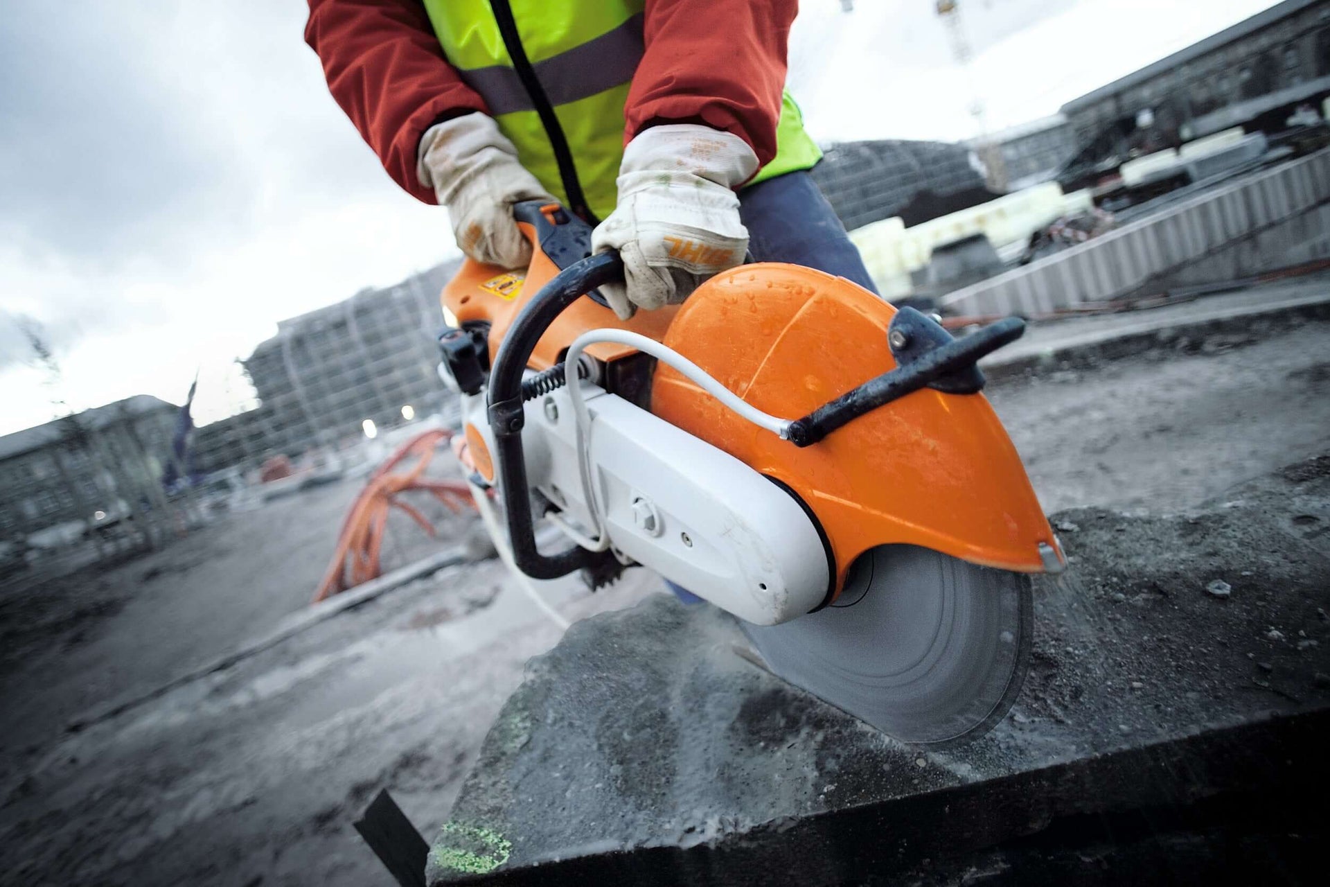 STIHL cut-off machine in use on construction site, ideal for tree surgeons and professionals tackling tough materials.