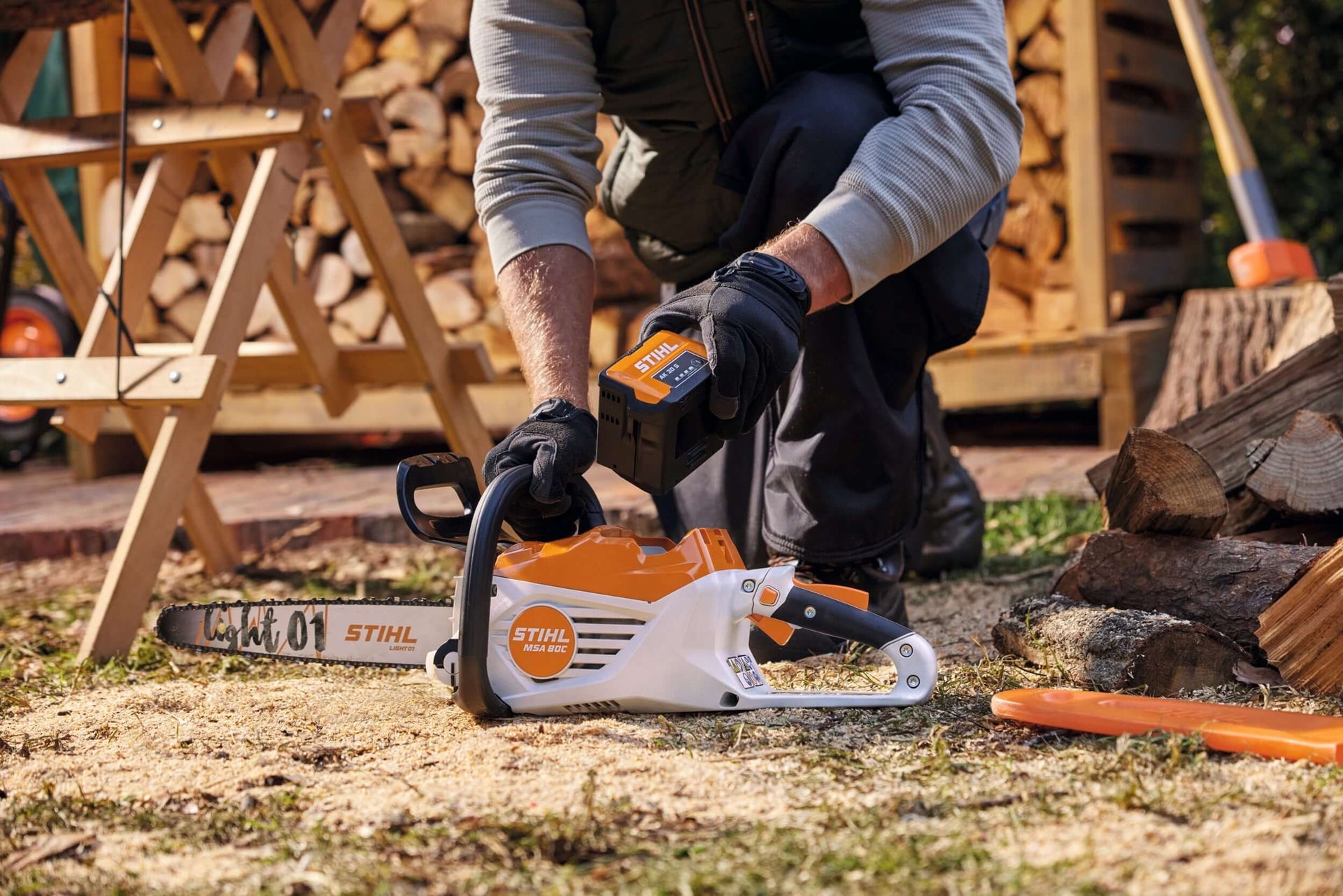 User handling a STIHL chainsaw for firewood processing outdoors, showcasing power and precision for tree surgeons.