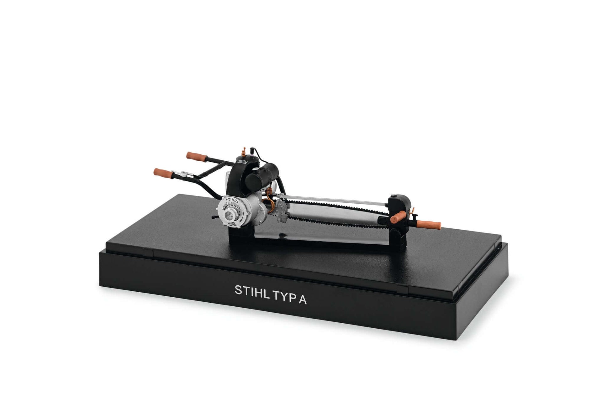 STIHL Typ A miniature model displayed on a black base, showcasing historical machinery for tree surgeon collectors.