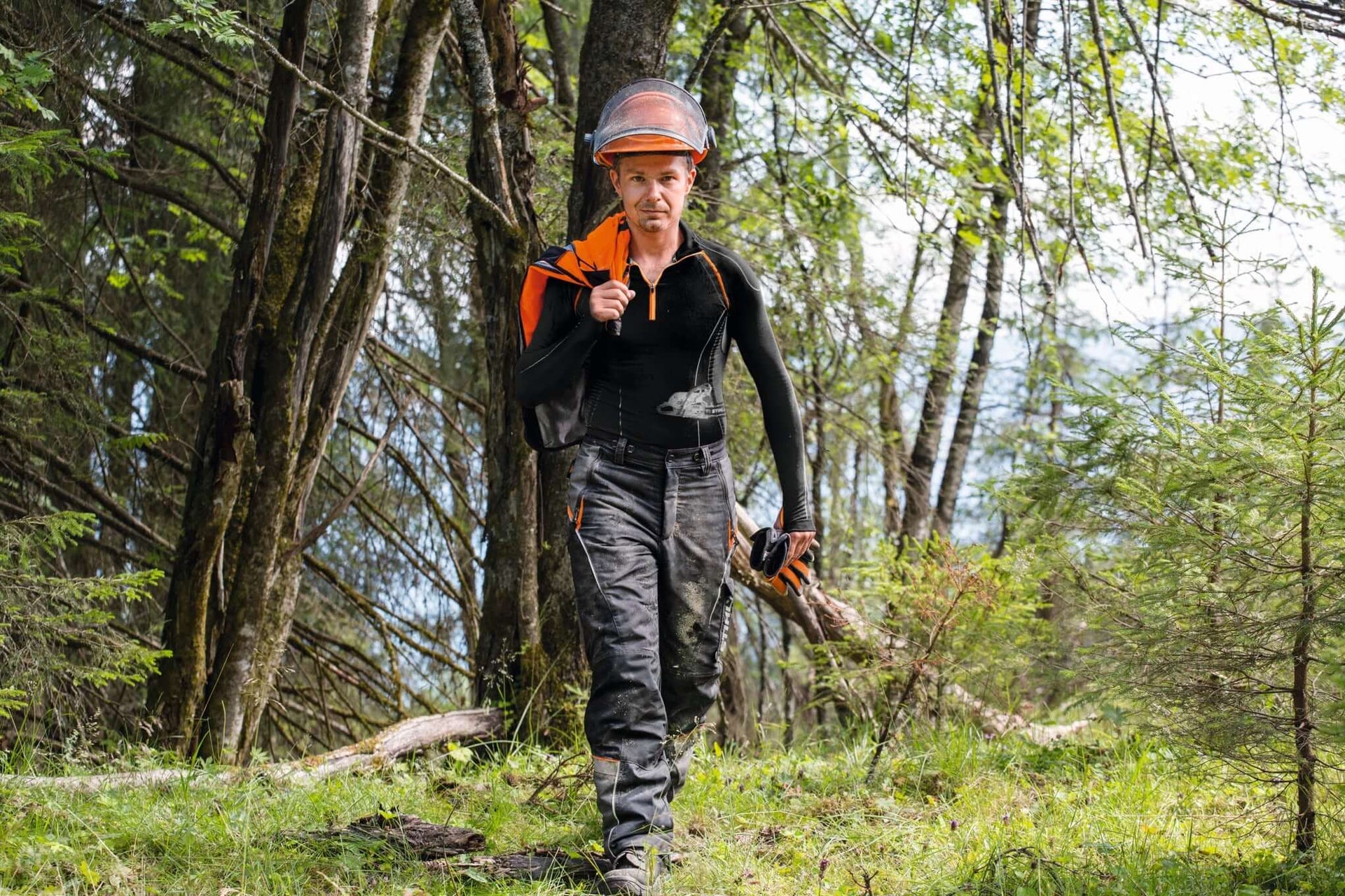 STIHL Base Layer clothing for arborists in a forest setting, providing comfort and moisture control.