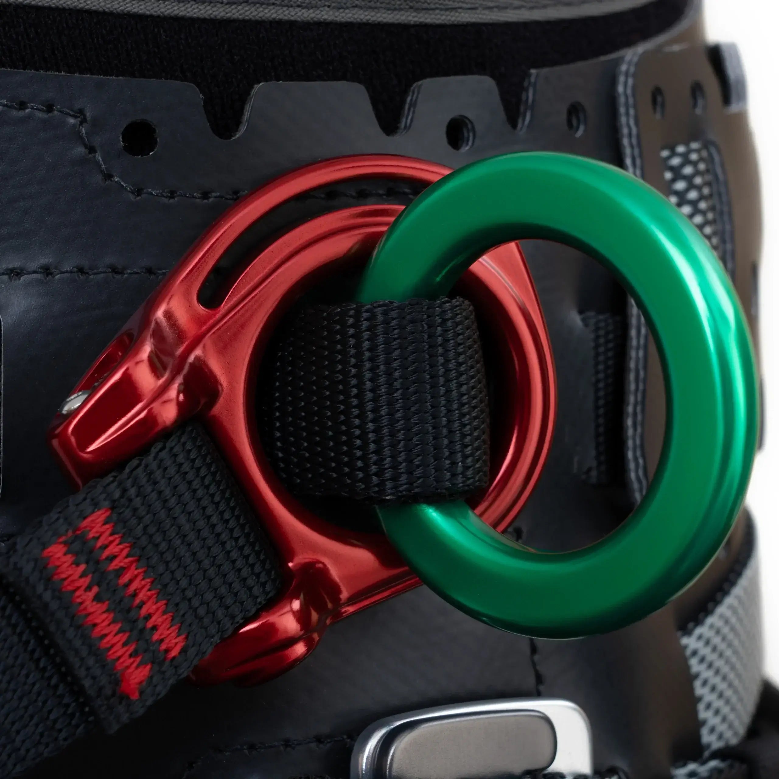 Close-up of a harness ring with vibrant green and red accents, designed for tree surgeons. Durable and functional gear.