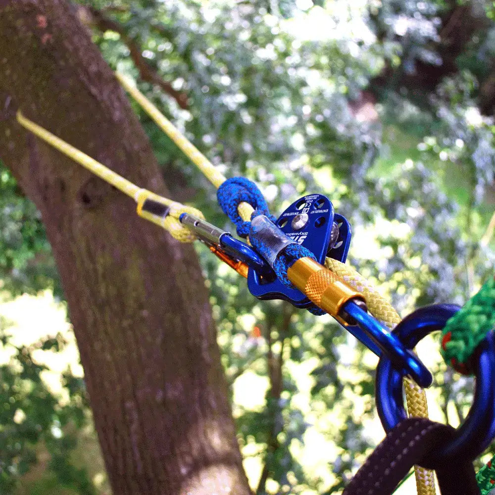 Climbing gear showing tree climbing ropes and carabiners, essential for tree surgeons and arborists.