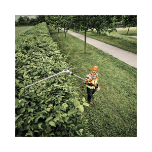 HLA 150 B Cordless Long-Reach Hedge Trimmer in use by a tree surgeon maintaining a tall hedge.