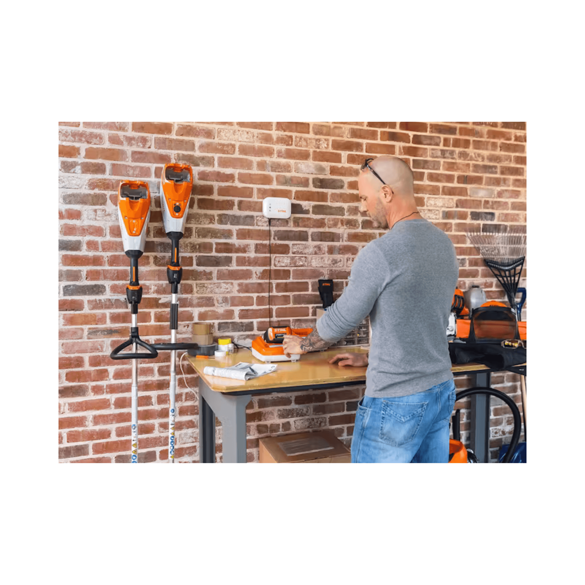 Tree surgeon working with STIHL equipment in a workshop, showcasing the AP 500 S Battery and tools.