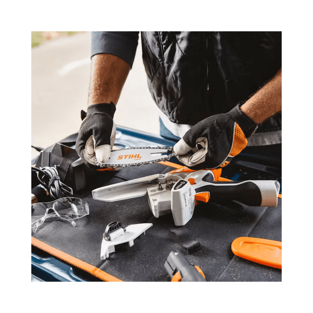 STIHL GTA 26 cordless pruning saw with accessories on a workbench for tree surgery.