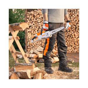 MSA 60 C-B Cordless Chainsaw 12" held by a person in protective gear near stacked firewood.