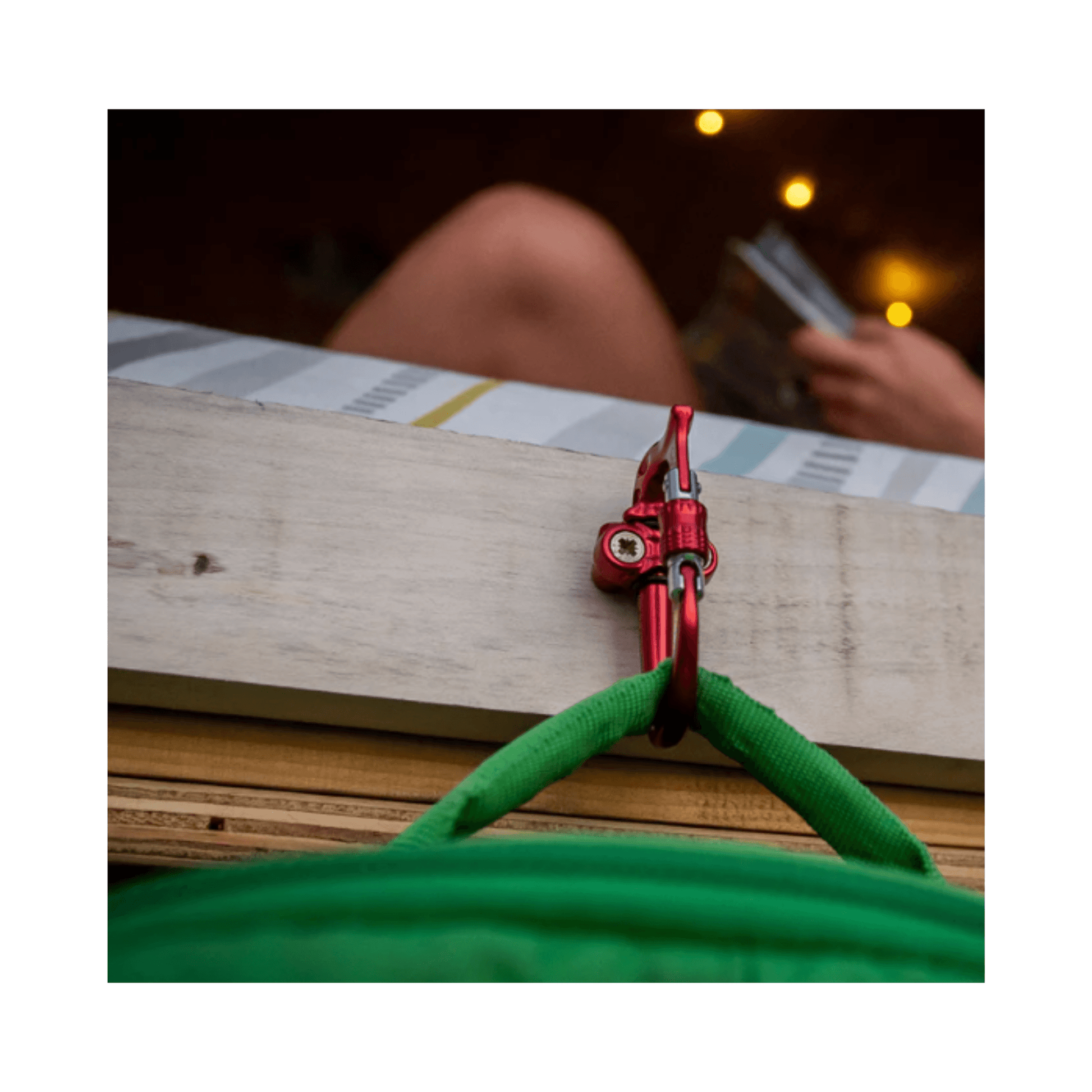 Micro Vault Tool Holder attached to a green rope with a red carabiner, showcasing versatile gear storage.