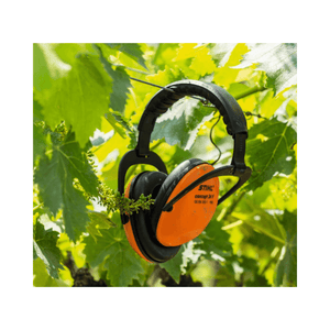 STIHL Concept 24 Ear Protection hanging among green leaves, ideal for tree surgeons and arborists.