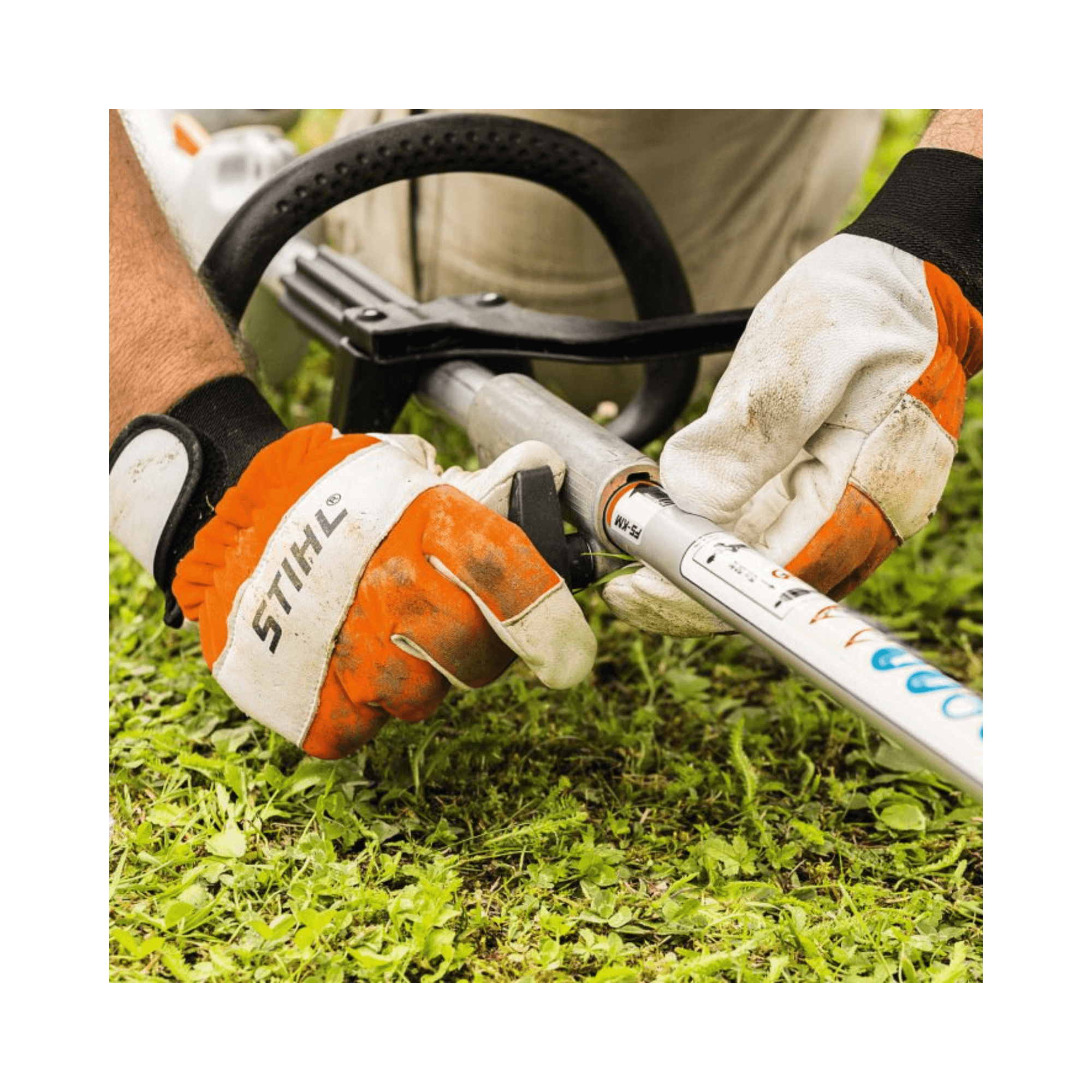 User operating the STIHL KM 56 RC-E Petrol KombiEngine in a garden setting.