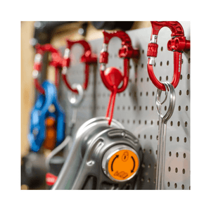 DMM Micro Vault Tool Holder with carabiners on a pegboard for organized gear and tool storage.