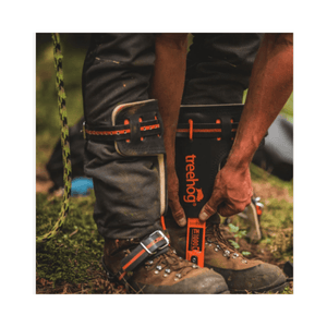 Person securing TH1000 Steel Tree Climbing Spikes before tree climbing work.