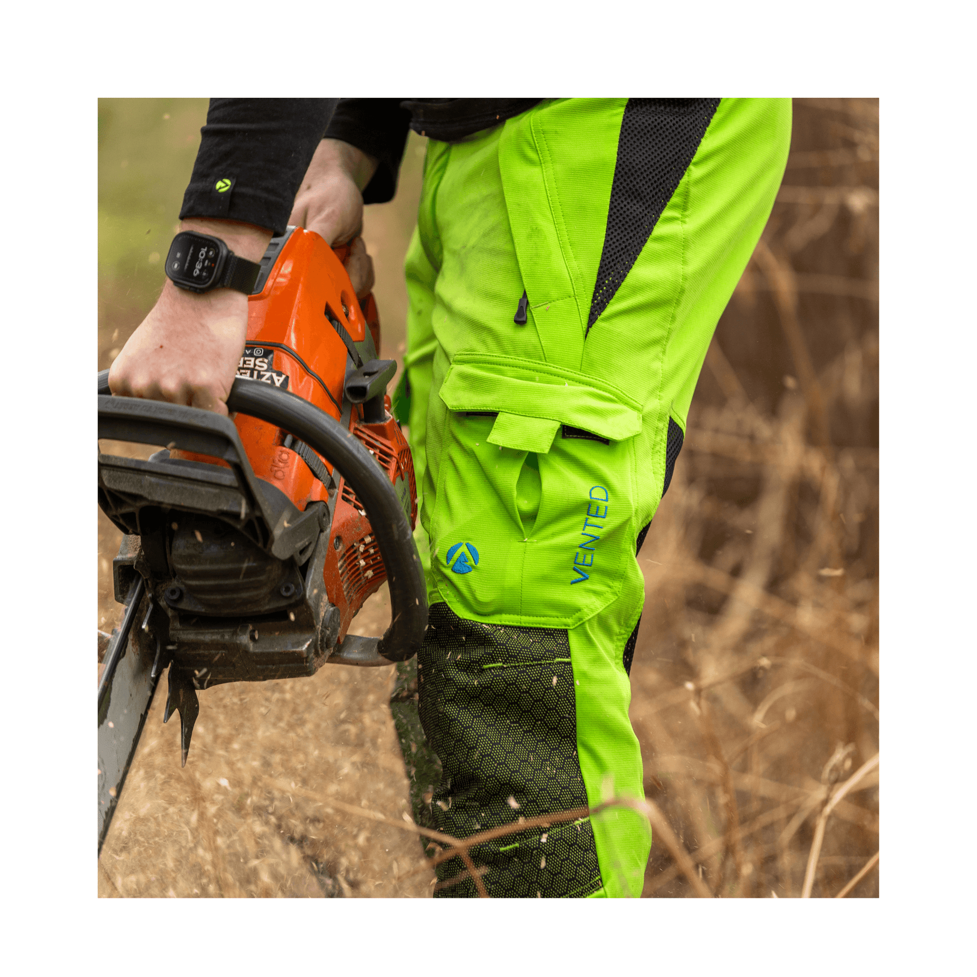 Vented Chainsaw Trousers Type A in action, worn by an arborist while using a chainsaw outdoors.