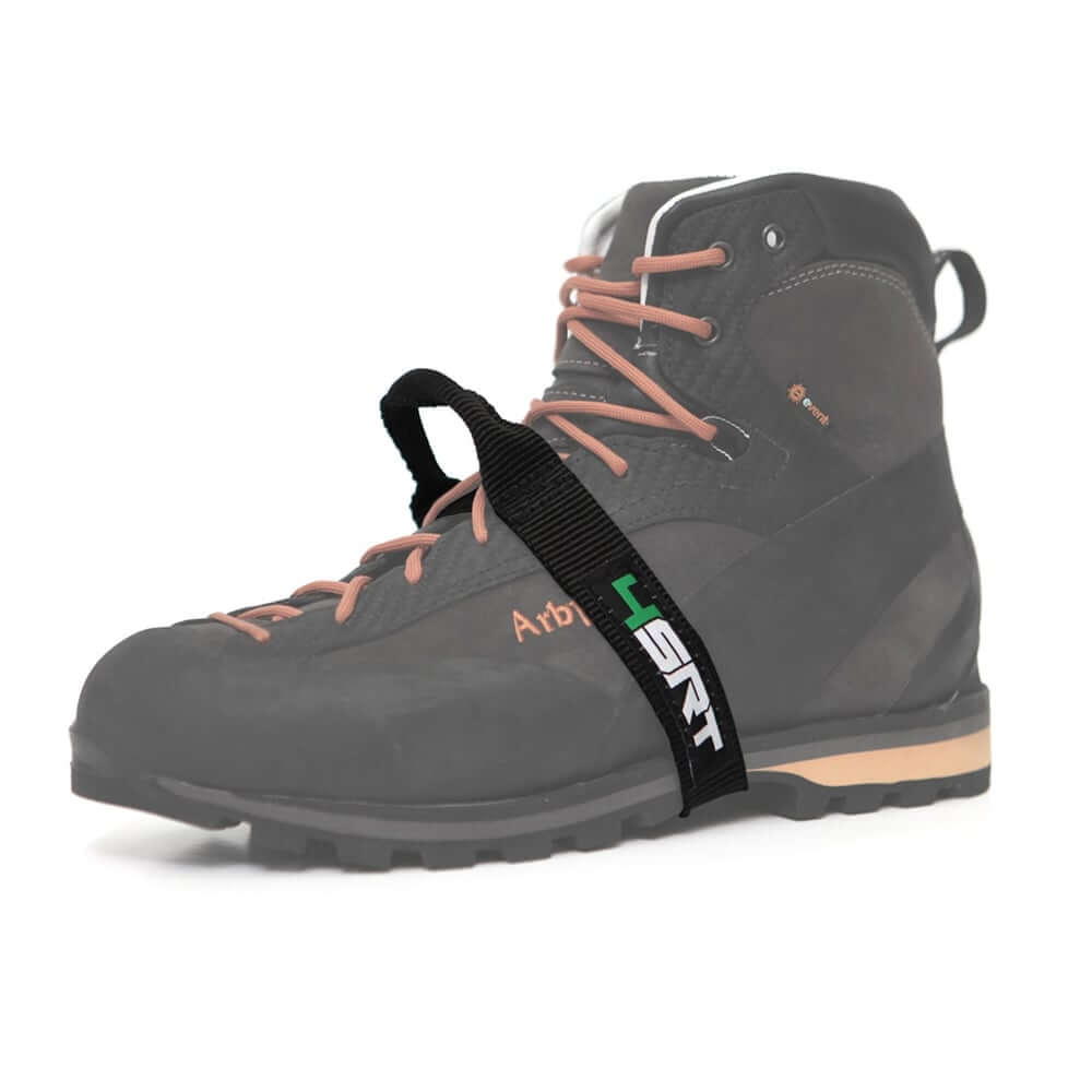 A black climbing boot with a foot ascender attached to it. The ascender is black with a visible brand logo '4SRT' in green.