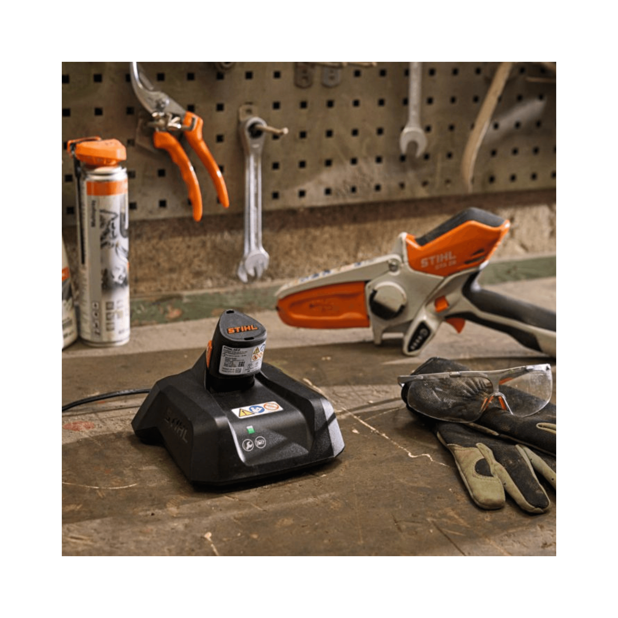 AL 5 High Speed Battery Charger on a workbench with STIHL tools and gloves, ideal for tree surgeons.
