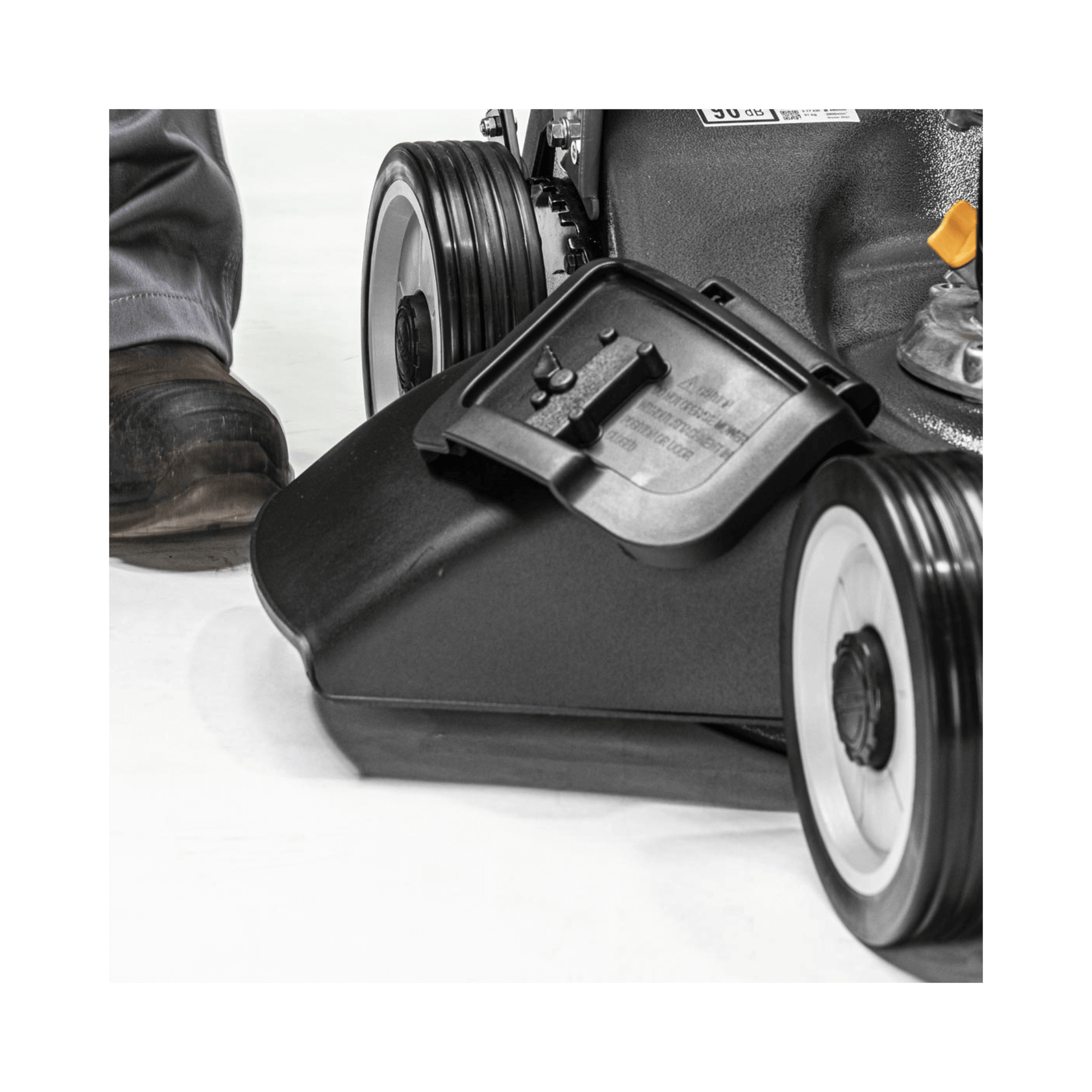 Close-up of the Weibang Virtue 46 SVP-H 4 in 1 Variable Speed Petrol Lawnmower's cutting deck and wheel.