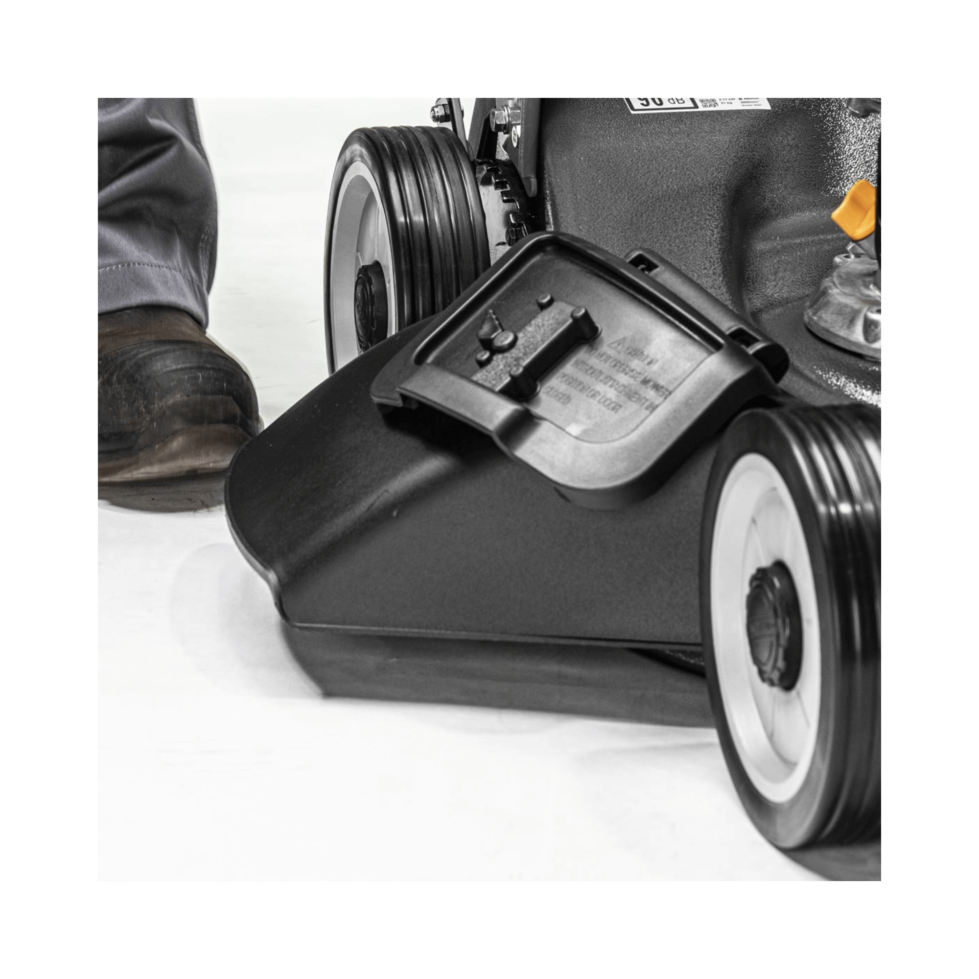 Close-up of the Weibang Virtue 46 SVP-H 4 in 1 Variable Speed Petrol Lawnmower's cutting deck and wheel.