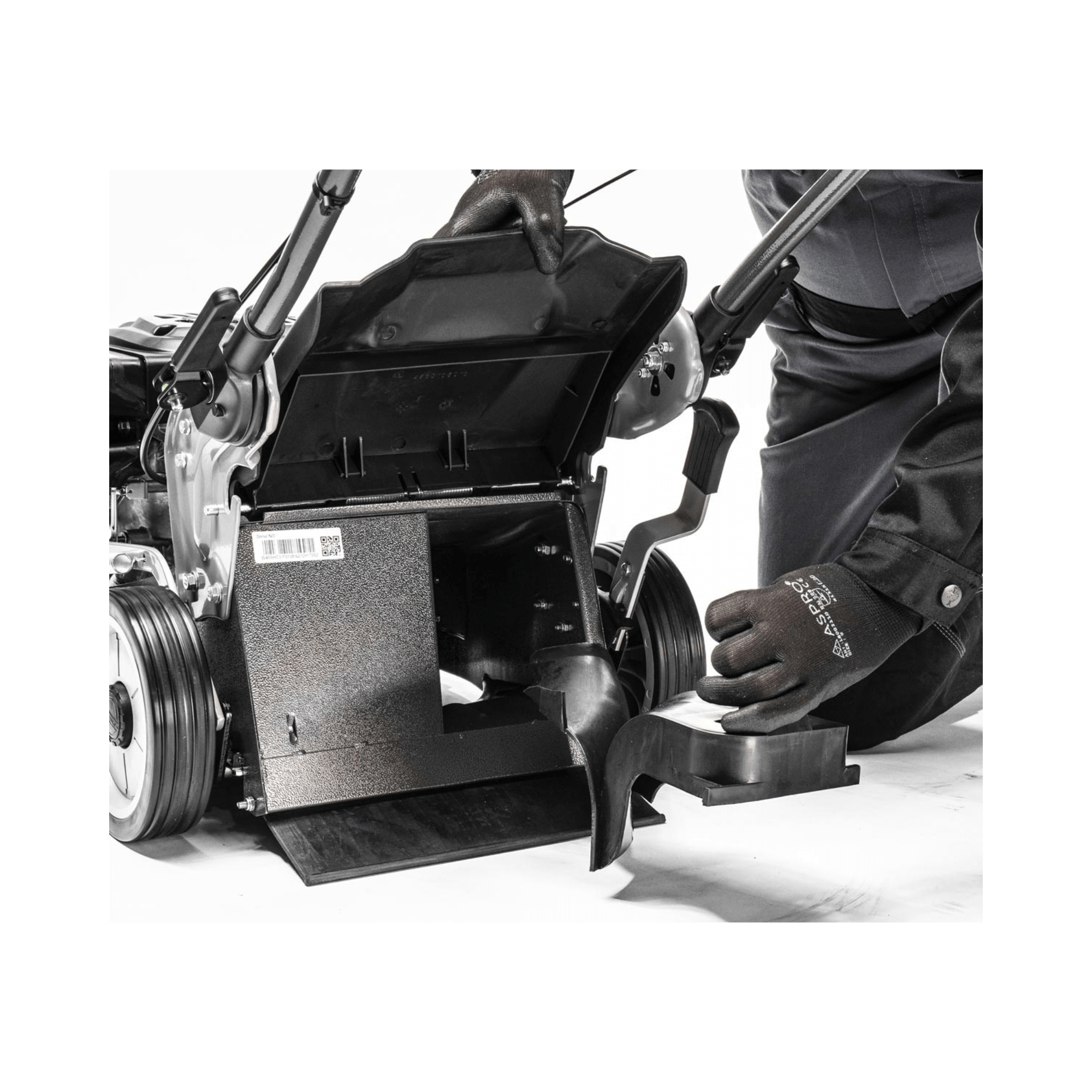 Virtue 50 SVP Variable Speed 4 in 1 Petrol Lawnmower maintenance with user adjusting the components.