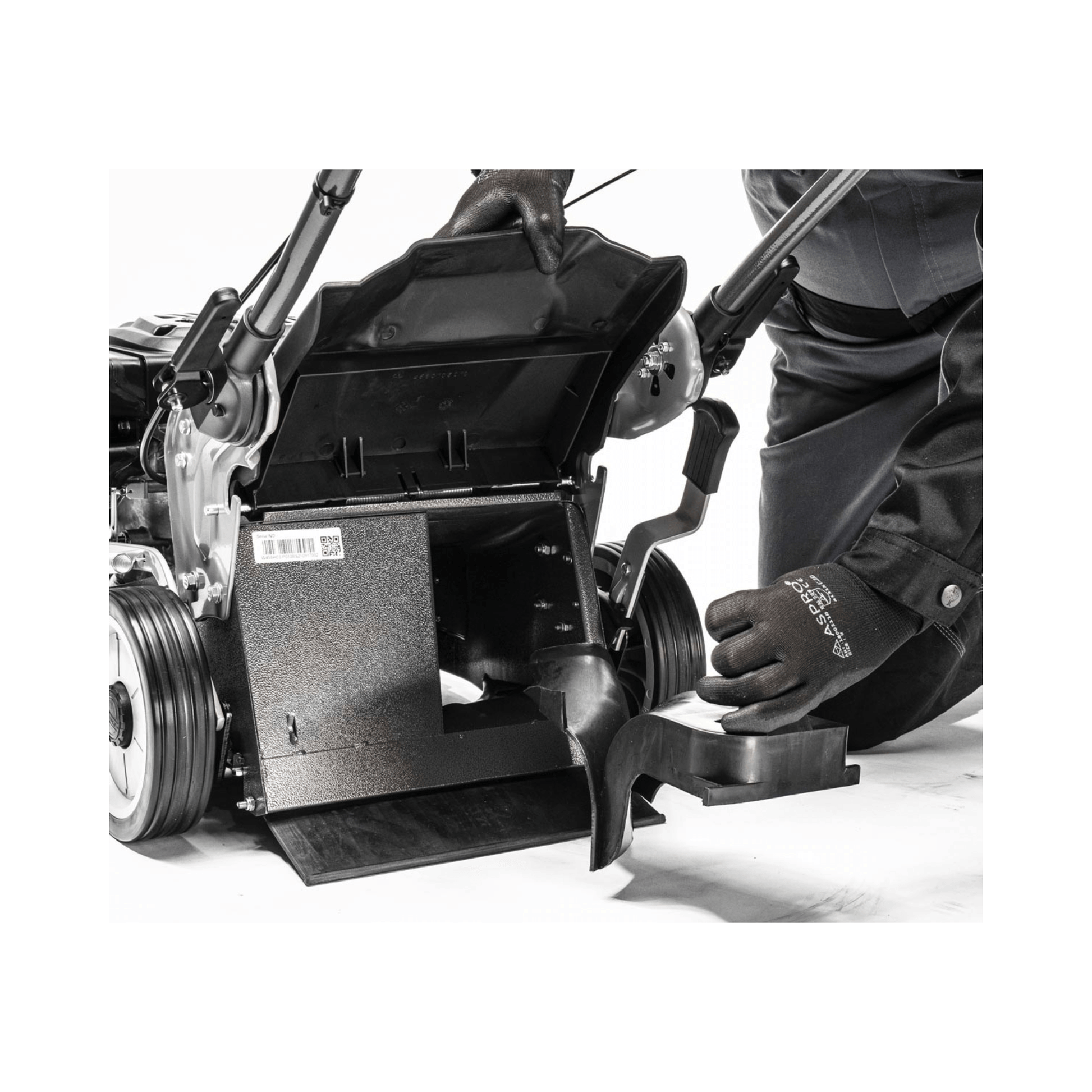 Virtue 50 SVP Variable Speed 4 in 1 Petrol Lawnmower maintenance with user adjusting the components.