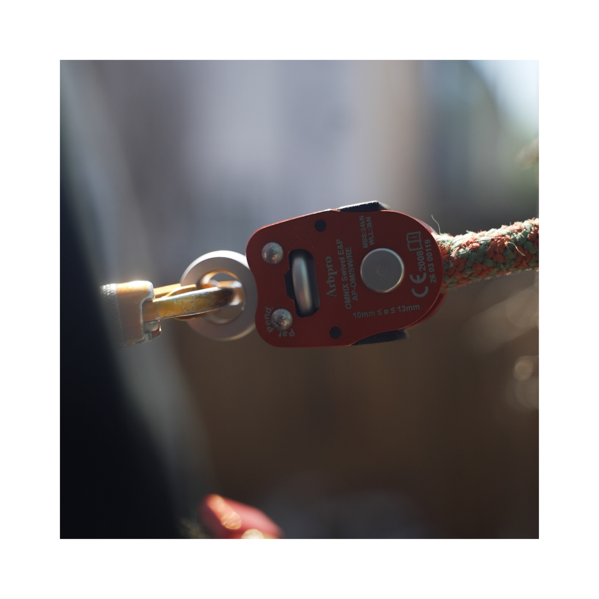 Close-up of ArbPro Omnix Swivel Eye&Pin connected to a rope, enhancing climbing stability and movement.