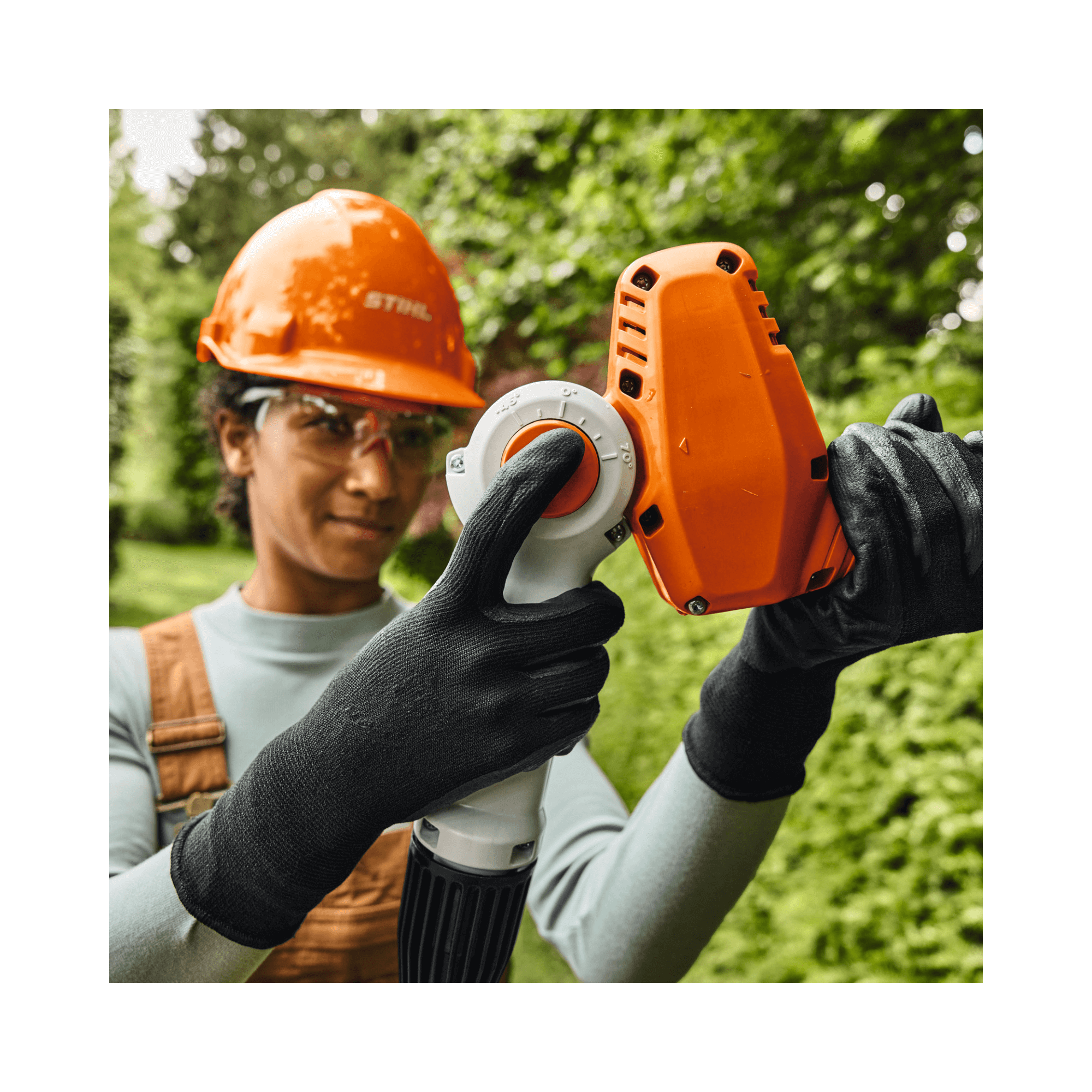 User operating the HLA 40 Cordless Telescopic Long-Reach Hedge Trimmer for precise trimming, great for arborists.