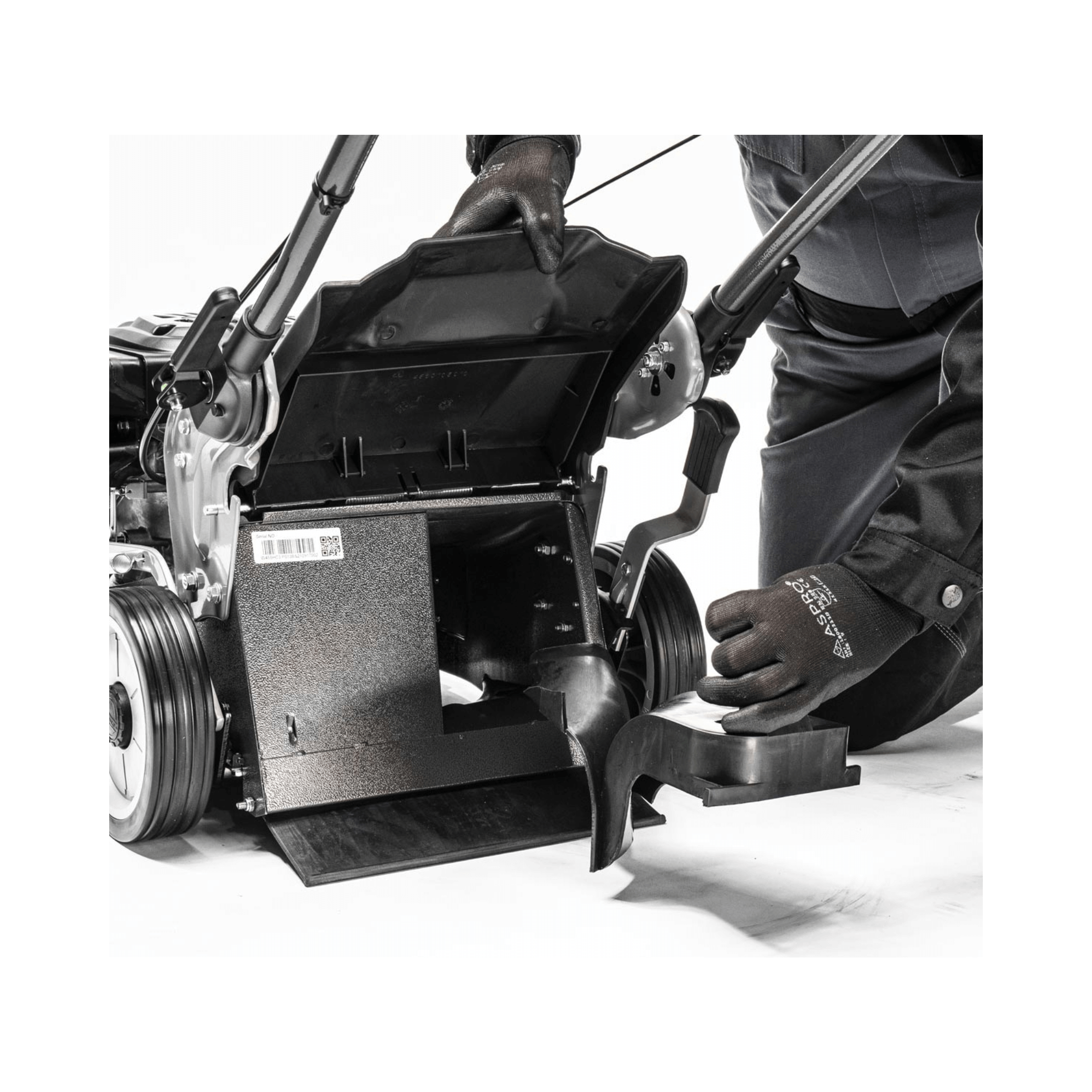 Virtue 46 SPP Push Lawnmower Petrol Lawn Mower showing maintenance with a tree surgeon adjusting components.