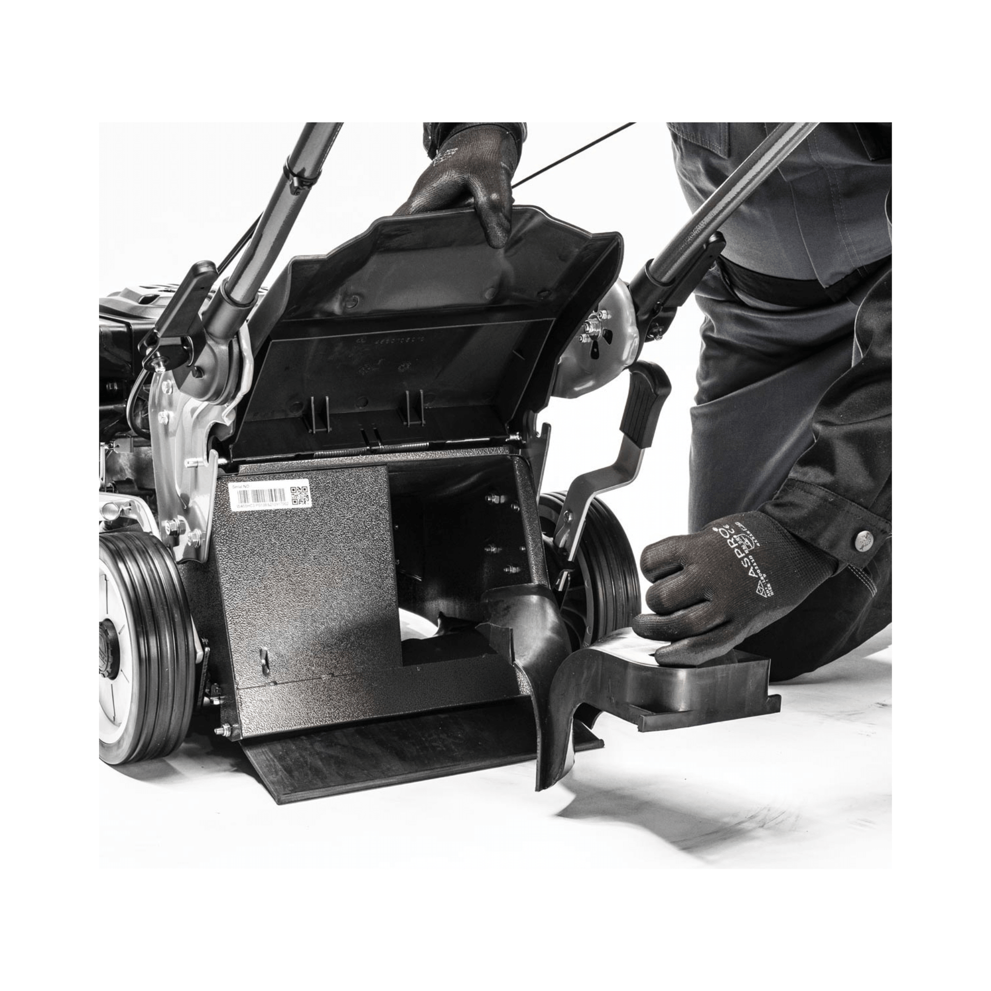 Virtue 46 SPP Push Lawnmower Petrol Lawn Mower showing maintenance with a tree surgeon adjusting components.