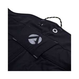 Close-up of the waistband label on Vented Chainsaw Trousers Type A, showcasing the brand logo and button details.