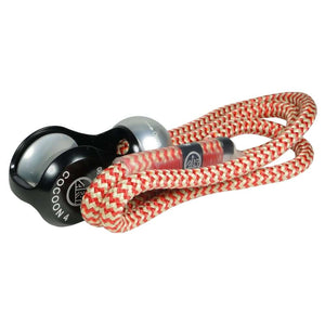 A Cocoon climbing protection device with a red and white rope threaded through its pulley system.
