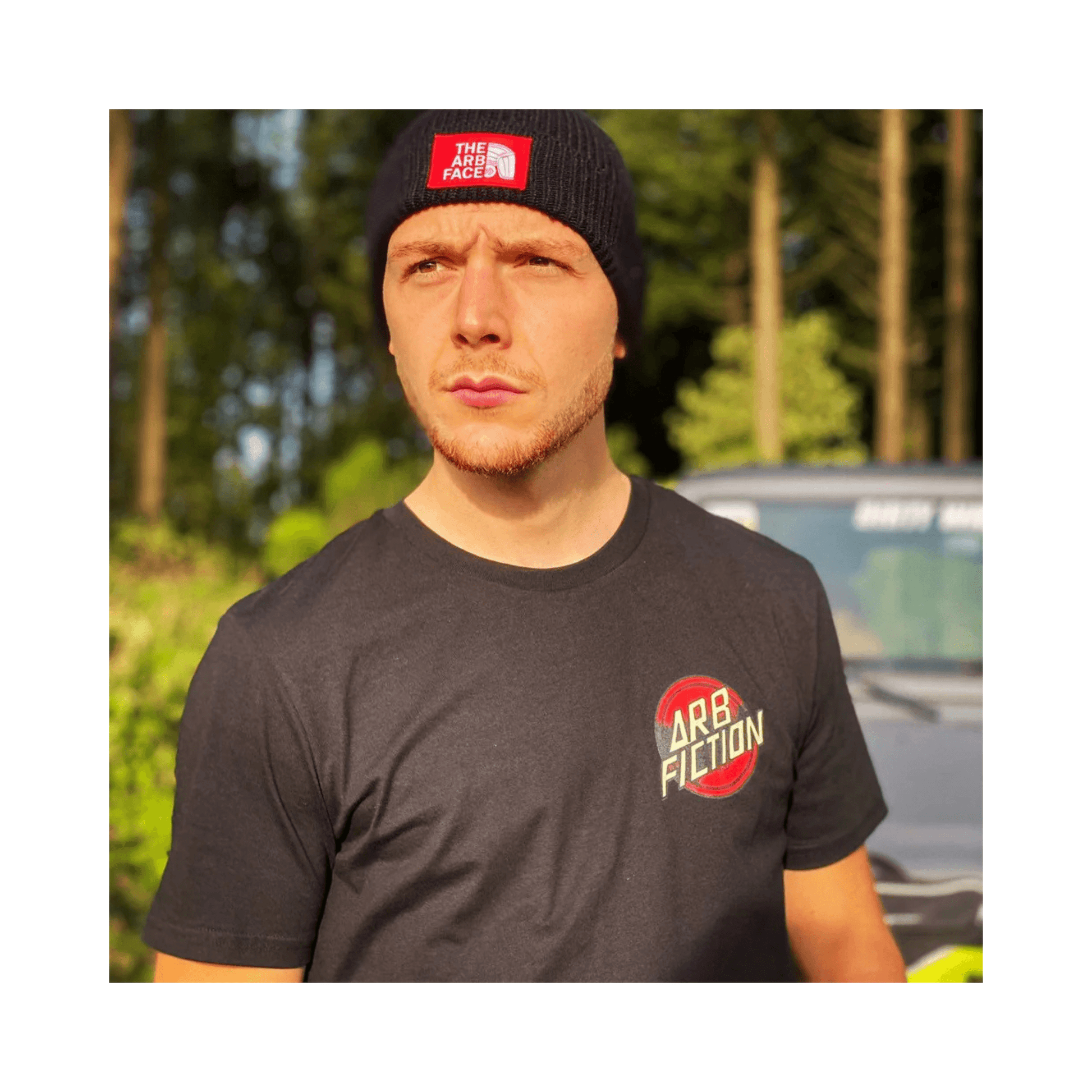 Man wearing Arb Fiction Screaming Hand T-Shirt in a forest setting, ideal for tree surgeons and outdoor enthusiasts.
