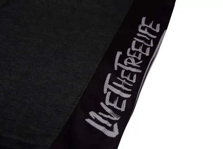 Close-up of the Arbortec Performance T-Shirt showing 'Live the Tree Life' text design in black.