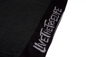 Close-up of the Arbortec Performance T-Shirt showing 'Live the Tree Life' text design in black.