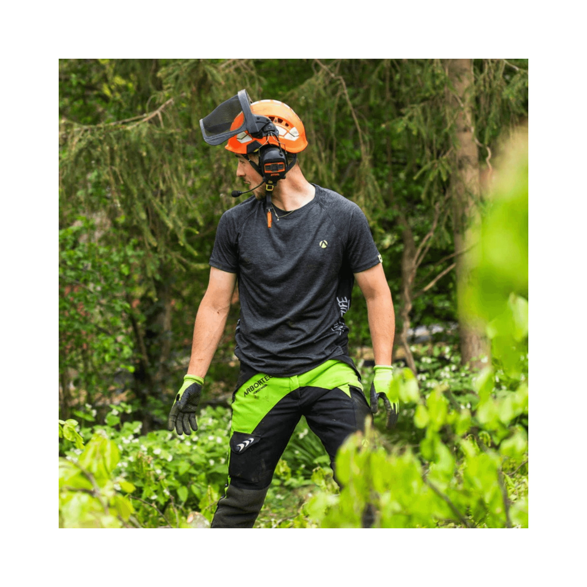 Breatheflex Chainsaw Trousers Black/Lime Type C Class 2 worn by a tree surgeon in green foliage.