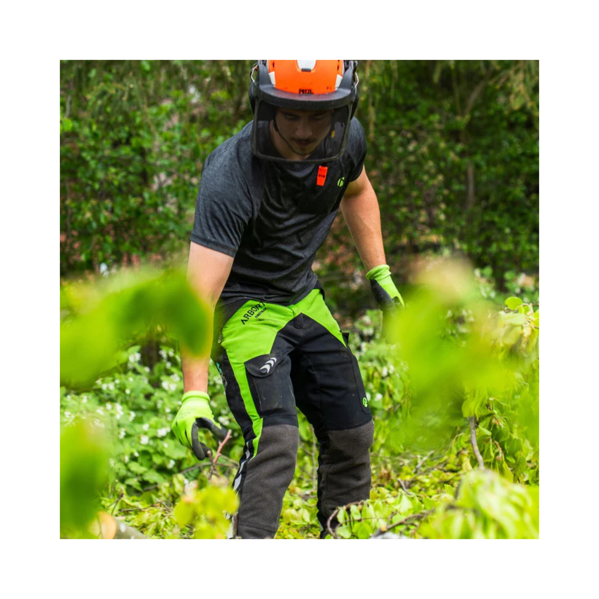 Breatheflex Chainsaw Trousers Black/Lime Type C Class 2 worn by a tree surgeon in action among greenery.