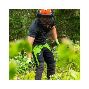 Breatheflex Chainsaw Trousers Black/Lime Type C Class 2 worn by a tree surgeon in action among greenery.