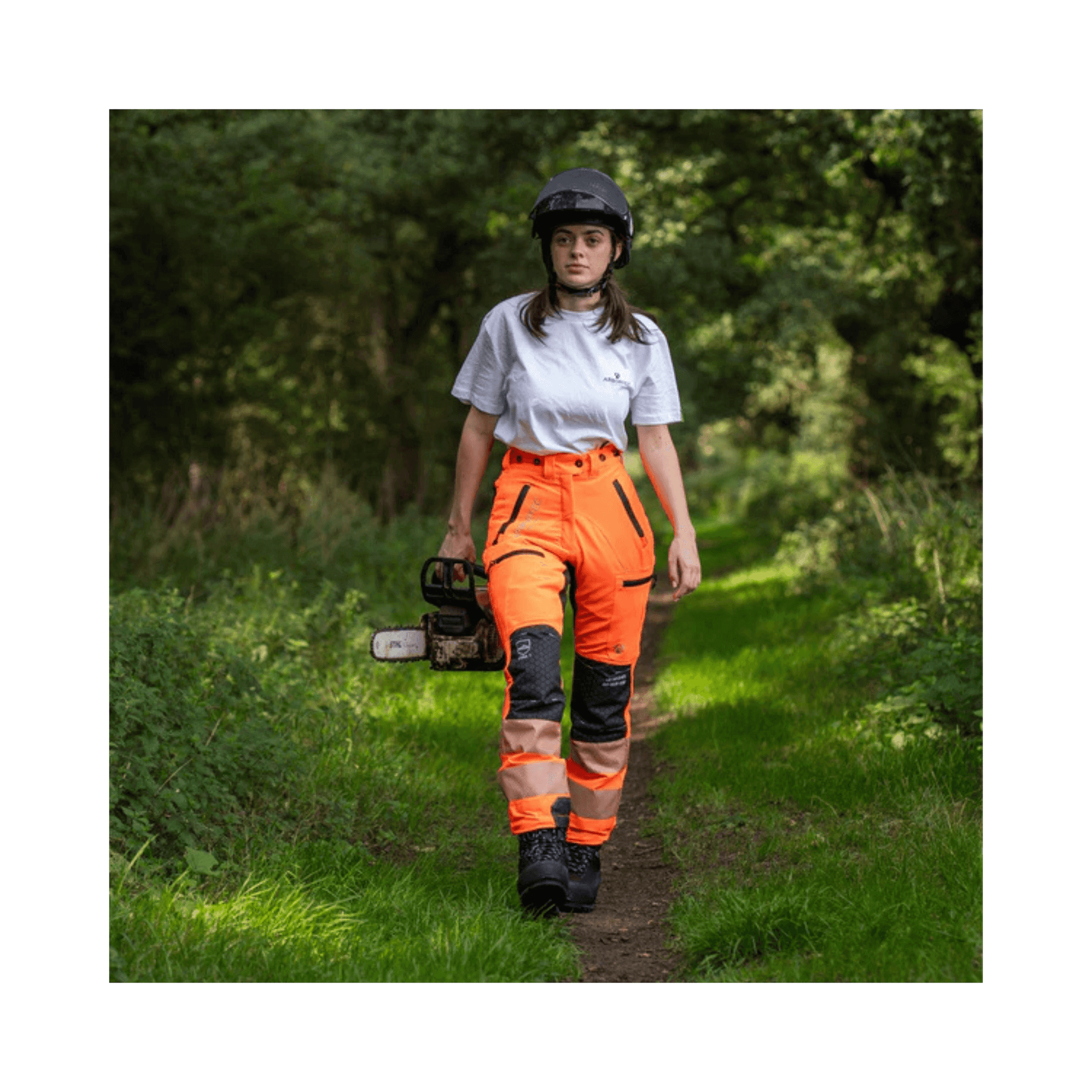 Breatheflex Pro Womens Chainsaw Trousers Type A Hi-Vis Orange worn by a woman in a forest setting.